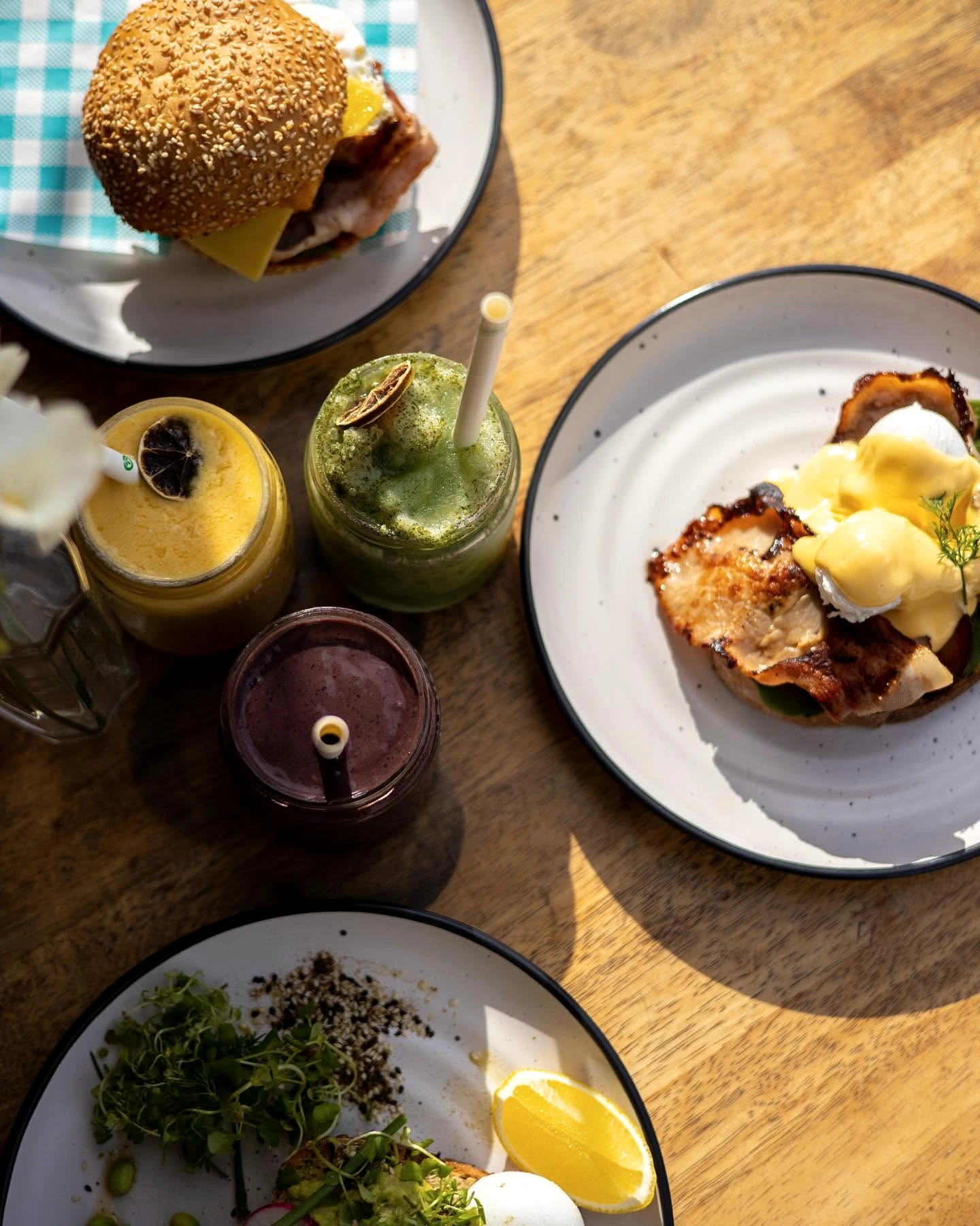Brunch and cold drinks on a sunny table at Lotus Cafe